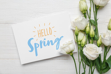 Wall Mural - Greeting card with text HELLO SPRING and beautiful eustoma flowers on white wooden background