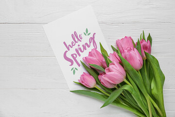 Wall Mural - Greeting card with text HELLO SPRING and beautiful pink tulips on white wooden background