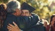 © Tazzi Art - Young man in his graduation gown and cap, hugging her parents at the graduation ceremony