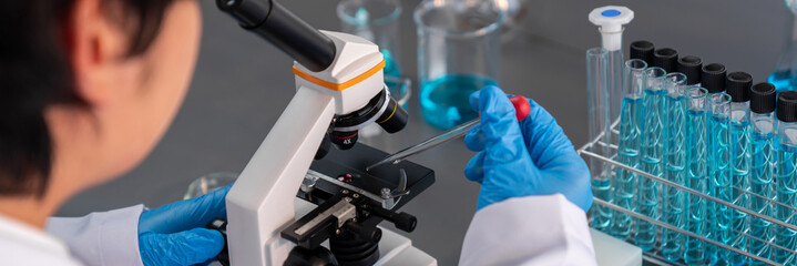 Poster - scientist conduct chemical experiment using microscope in medical laboratory to develop new vaccine 