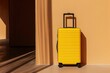 a yellow suitcase is sitting on the floor in front of a wall