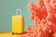 a yellow suitcase is sitting on a table next to a pink tree