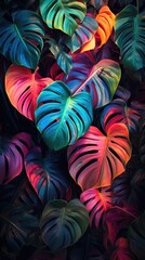 Wall Mural - Large tropical leaves in neon colors. Creative fluorescent picture of exotic leaves.The concept of nature.