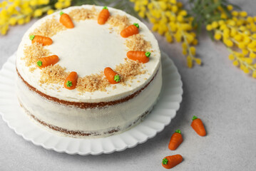 Wall Mural - Homemade carrot cake made with walnuts, iced with cream cheese. Sweet dessert.