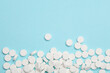 canvas print picture - White pills on a blue background. Copy space