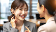 © Purple White - 20代の補聴器を付けた女性会社員が同僚と談話している