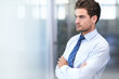 © Mariusz S/peopleimages.com - Businessman, face and serious with arms crossed in office for professional career in finance, thinking and confidence. Entrepreneur, person and employee with relax, thoughtful or mockup space at work