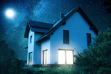 Fototapeta Miasto - Exterior of an Illuminated Single-Family Home at Night Under a Starry Sky