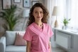 © Road Red Runner - A female registered nurse wearing a pink scrub suit stands in a living room, preparing for work.