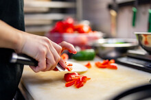 Chefs Woman Hands Chopping Red Pepper On Board