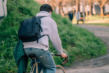 Poster - young man on the street riding on vintage bicycle