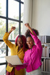 © Natee Meepian - Two african woman celebrate when business goal success. achievement and business goal success concept