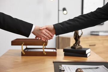 Sticker - Notary shaking hands with client at wooden table in office, closeup