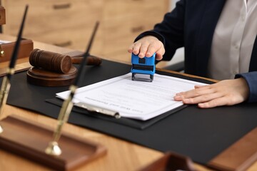 Canvas Print - Notary stamping document at table in office, closeup