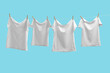 T-shirts drying on washing line against light blue background