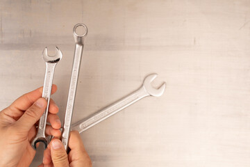 Poster -  Metal wrench in male hand isolated on white