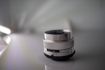 Wall Mural - Close-up of camera,Close-up of hand holding camera lens,Old vintage camera placed on a blurred background.