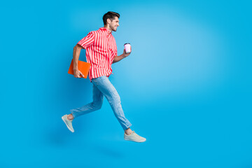 Aufkleber - Full size photo of clever man dressed striped shirt run look empty space hold laptop cup of coffee isolated on blue color background