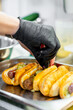 © pavel siamionov - Chef hand cooking set hot dog on kitchen