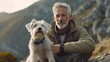 Mature gray haired man spending time outdoors with his small cute Jack Russell Terrier in mountain nature.