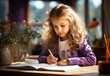 © Kavindu - child is doing her homework in a book on a desk