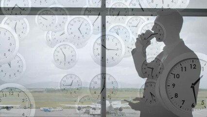Poster - Animation of falling clocks with fast hands over caucasian businessman at airport using smartphone