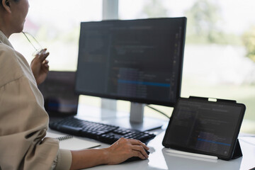 Developer programmer working to checking code on monitor while programming to developing website