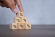 © izzuan - Hand arranging stacking wooden blocks with percentage icon. Debt restructure concept.