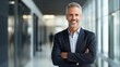 © elena_garder - Smiling mature adult business man in modern office. Happy busy professional mid aged businessman ceo manager