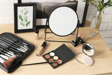 Canvas Print - Mirror, makeup products and pictures on wooden dressing table