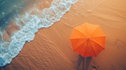 Poster - an orange umbrella sitting on top of a sandy beach next to a wave crashing on top of a body of water.