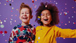 © NK Project - Portrait of two children, boys of different nationalities in yellow and white t-shirt posing and laughing together at a holiday party with confetti on purple background