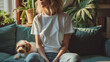 girl in white t-shirt sitting on a sofa with a dog