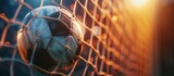 Fototapeta Sport - Soccer ball breaks the soccer net with copyspace for text