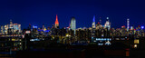 Fototapeta Miasta - New York City Night Skyline, Skyscrapers, and Reflections, a vibrant beautiful aerial panoramic view from Brooklyn of the iconic metropolis of America