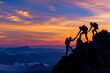 © somsuda - A group of hikers team with backpacks helping each other hike up a mountain. Adventurous lifestyle. Teamwork concept.