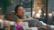 Relaxed Asian woman lying on massage table, receiving body massage, enjoying Thai spa in salon