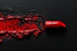 Red lipstick smear on a black background, high contrast makeup concept