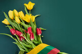 Fototapeta Mapy - Congratulation for March 11, Lithuania Independence Day. Lithuanian tricolor and bouquets of tulips