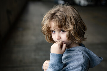 Aggressive child fight. Little kid boy fighting outside. Angry little boy showing fist. Portrait of fight kid. Bullied, physical abuse, children fighting. Aggression little boy. Kids bad behavioral.