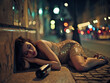 © J S - Wasted girl in fancy dress passed out after party and sleeping on night street, empty bottle on sidewalk