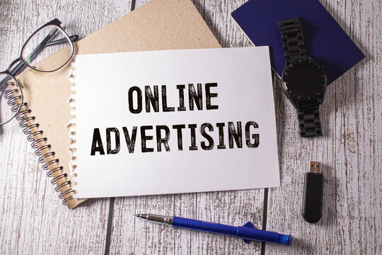 Online Advertising text on a white folder on grey background.