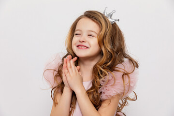 Wall Mural - Cute little girl makes a wish on the birthday party. Happy girl celebrating her birthday. copy space.