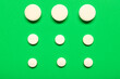 canvas print picture - Composition with white pills on green background