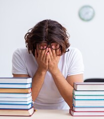 Poster - Young male student sitting in the classroom