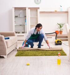 Wall Mural - Young businessman cleaning the house