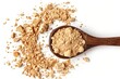 Wooden spoon holds a portion of maca powder against a clean white background.