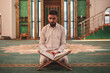 Muslim man praying in mosque and reading Quran