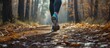 Female jogger in sneakers running on forest trail, captured in a cinematic freeze frame, preparing for a marathon.