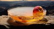 a bowl of peach oil on a table with a natural scenery background